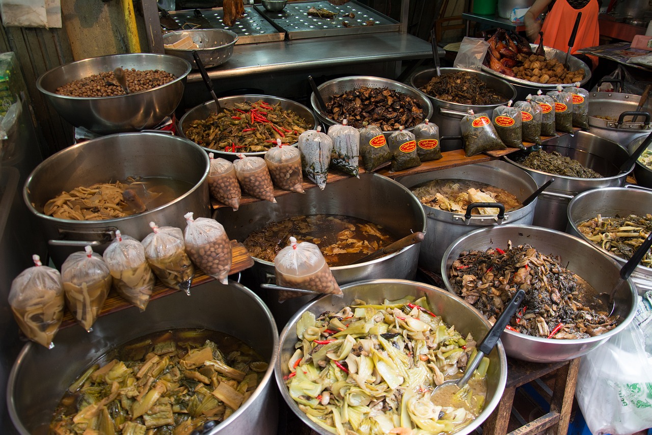Vendor preparing traditional Thai dishes at a night market